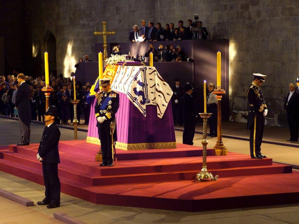 Prince Charles stands in vigil at the coffin of his grandmother, the queen mother, on April 8, 2002, in Westminster Hall. Pool Photo/Getty Images