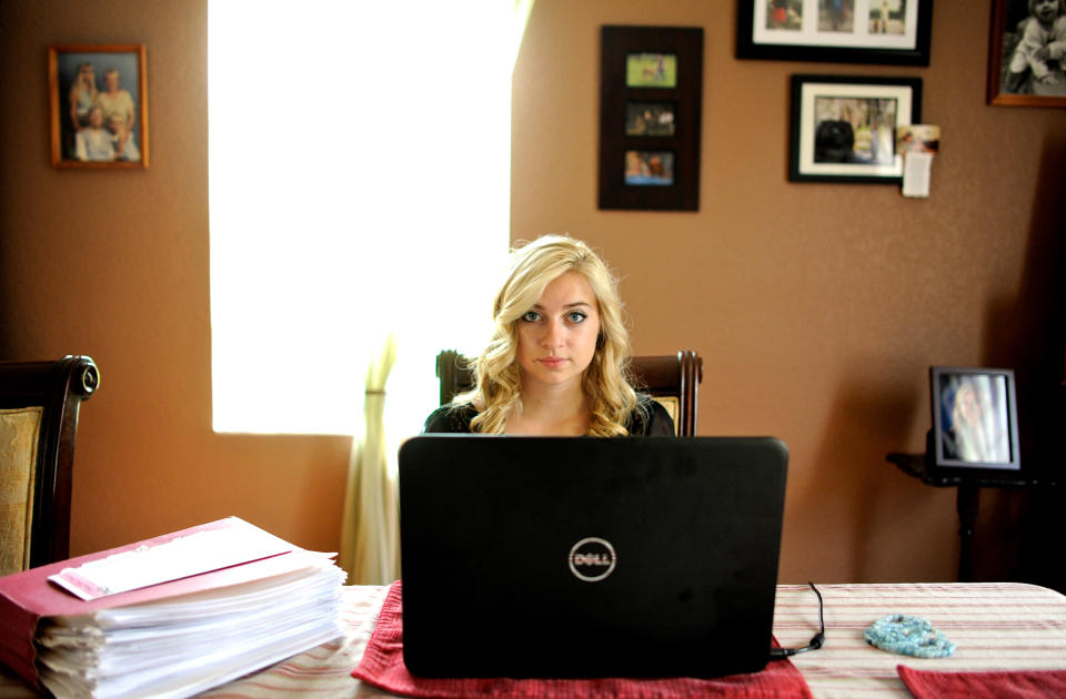 Sarah Ball, a victim of cyber bullying during her high school years, sits for a portrait at her home on Wednesday, Oct. 23, 2013, in Spring Hill, Fla. Ball, now a student at a nearby community college, maintains a Facebook site called "Hernando Unbreakable", an anti-bullying page and mentors local kids identified by the schools as victims of cyberbullying. (AP Photo/Brian Blanco)