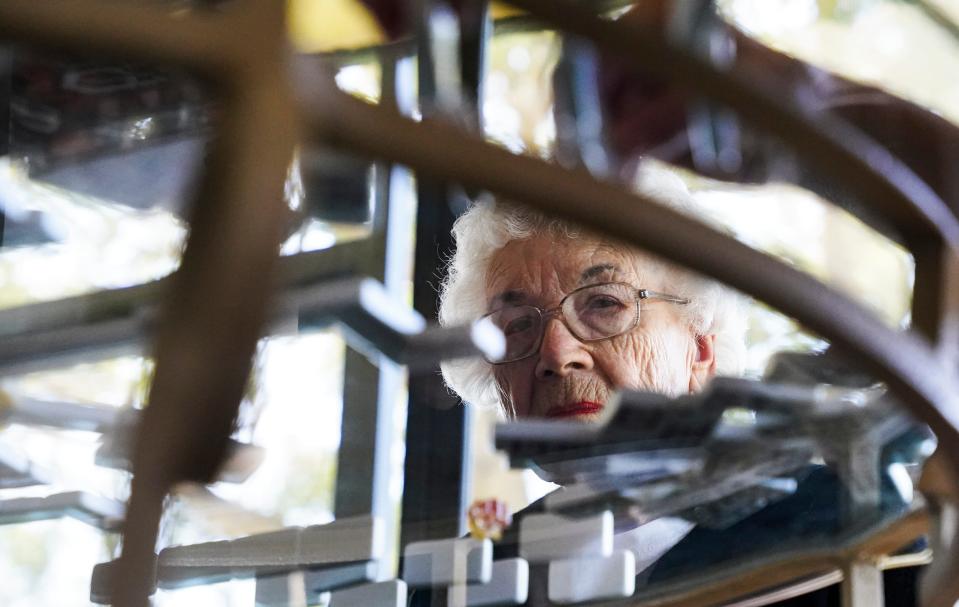 Lydia Kruesi, 100, makes a move while playing dominos with her family at Vi at Bentley Village retirement community in Naples on Monday, May 1, 2023.