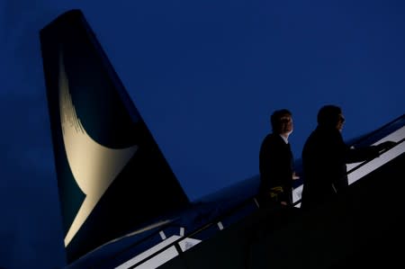 FILE PHOTO: Pilots walk up to a new Cathay Pacific Airways Airbus A350 after being received by the airline at Hong Kong Airport