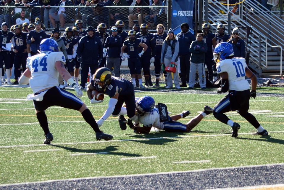 Shepherd's Josh Gontarek is brought down by Notre Dame's Bryce Sheppert after making a catch deep in Falcons territory.