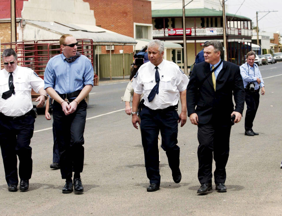 Murderer Robert Joe Wagner is escorted handcuffed by court sheriffs outside the disused bank vault in Snowtown in 2002. Source: AAP