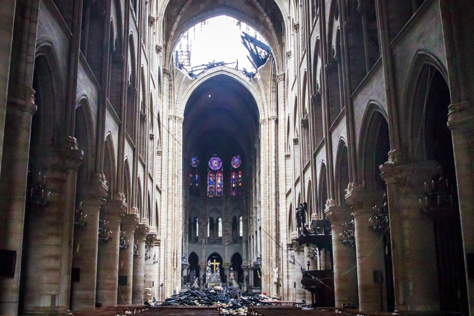 A hole is seen in the dome inside Notre Dame cathedral in Paris, Tuesday, April 16, 2019. Firefighters declared success Tuesday in a more than 12-hour battle to extinguish an inferno engulfing Paris' iconic Notre Dame cathedral that claimed its spire and roof, but spared its bell towers and the purported Crown of Christ. (Christophe Petit Tesson, Pool via AP)