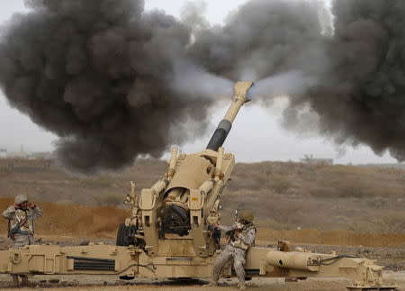 A Saudi artillery unit fires shells towards Houthi positions from the Saudi border with Yemen, April 13, 2015. REUTERS/Faisal Al Nasser