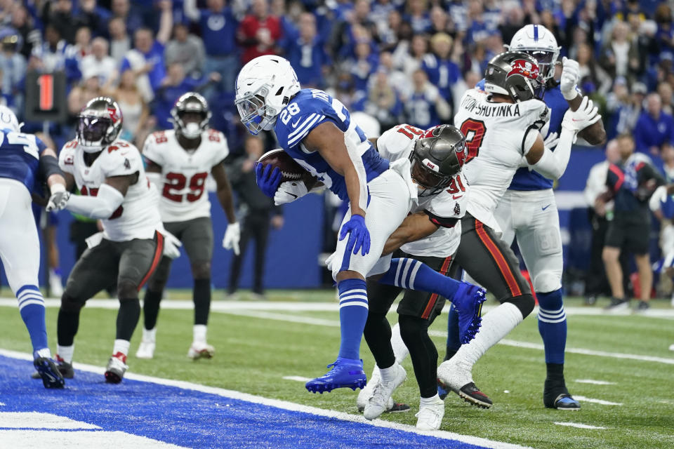 Indianapolis Colts' Jonathan Taylor (28) runs in for a touchdown against Tampa Bay Buccaneers' Antoine Winfield Jr. (31) during the second half of an NFL football game, Sunday, Nov. 28, 2021, in Indianapolis. (AP Photo/Michael Conroy)