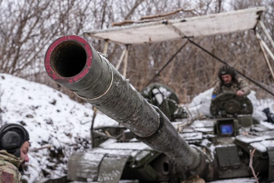 Ukrainian servicemen prepare to ride in a T-64 tank near the town of Bakhmut.