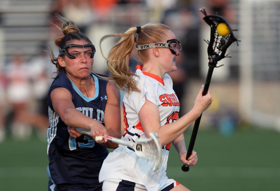 Greeley's Erica Rosendorf (10) drives to the goal in front of  Ursuline's Paige Moretti (13) during girls lacrosse Class A semifinal at Horace Greeley High School in Chappaqua May 23, 2023. Greeley won the game 11-8.