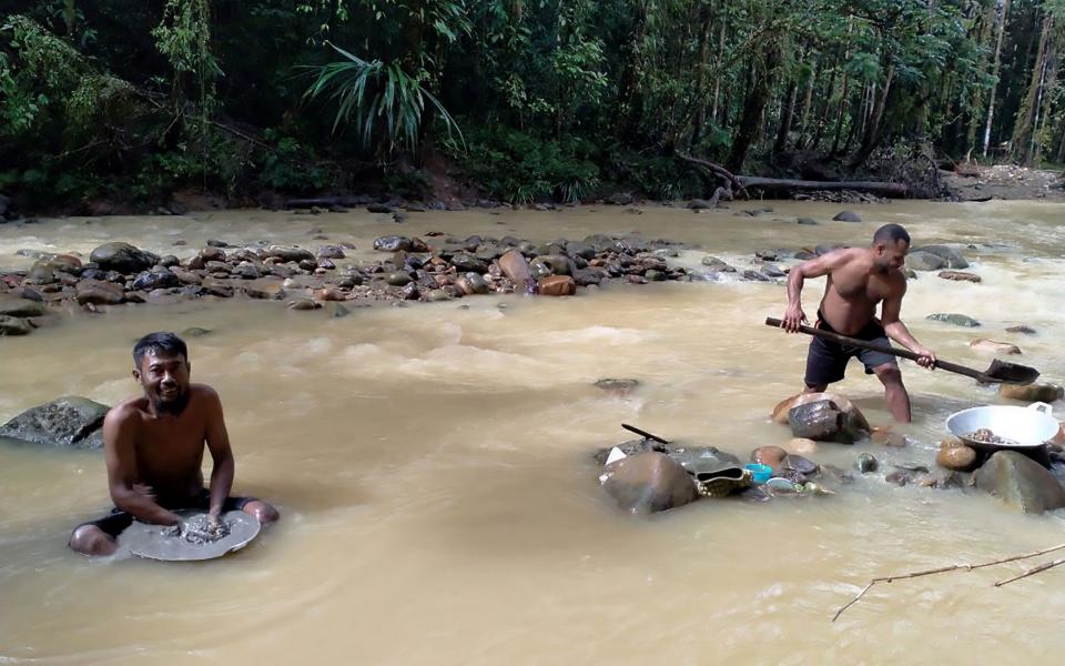 Miners panning for gold along a stream near Korowai, Papua province - AFP
