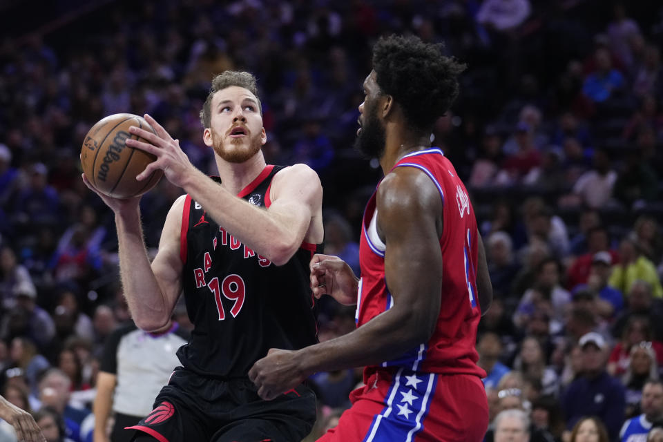 Toronto Raptors' Jakob Poeltl looks to shoot against Philadelphia 76ers' Joel Embiid during the first half of an NBA basketball game Friday, March 31, 2023, in Philadelphia. (AP Photo/Matt Rourke)