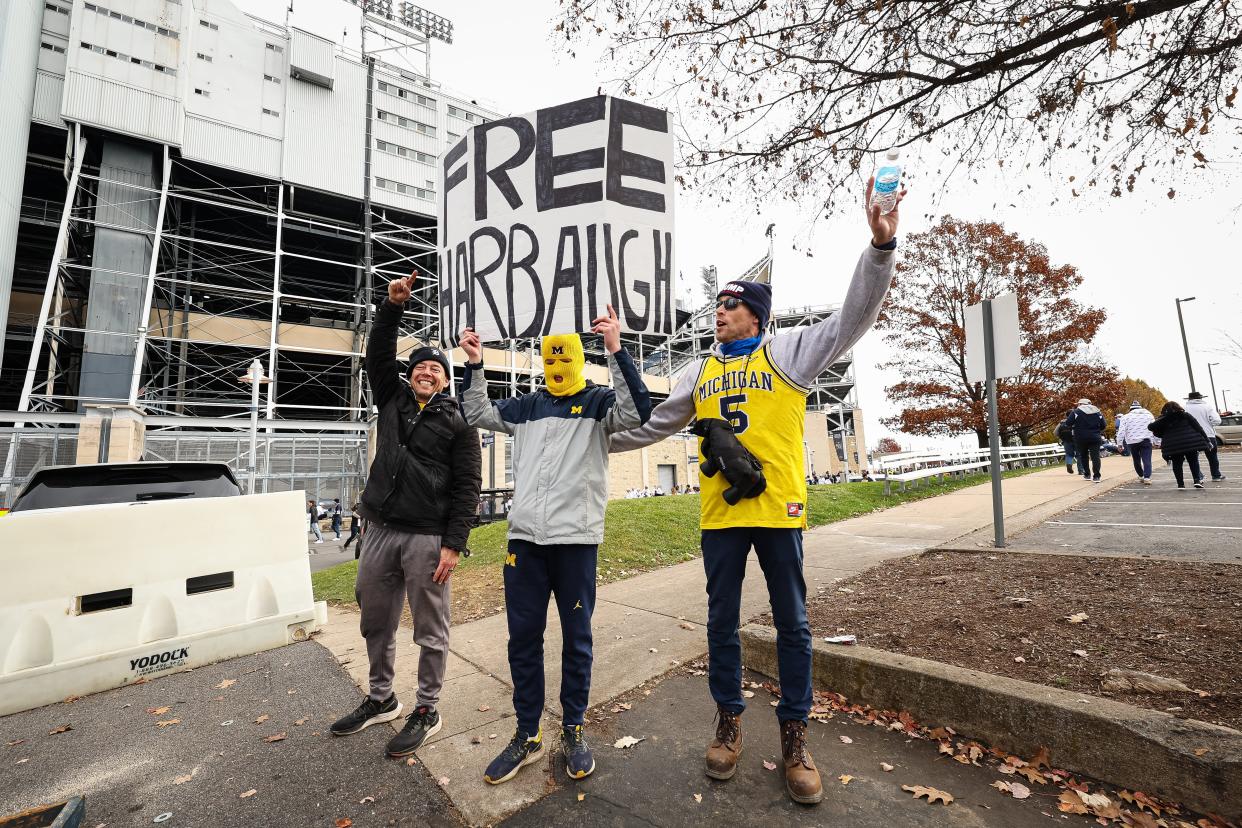 Michigan Wolverines fans hold a sign after the suspension of head coach Jim Harbaugh before the game against the Penn State Nittany Lions at Beaver Stadium on Nov. 11, 2023 in State College, Pennsylvania.