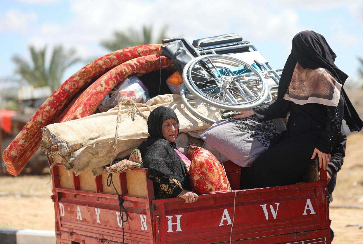 Displaced Palestinians who fled Rafah, ahead of a threatened Israeli assault, travel in Al-Mawasi area, in Khan Younis (Reuters)