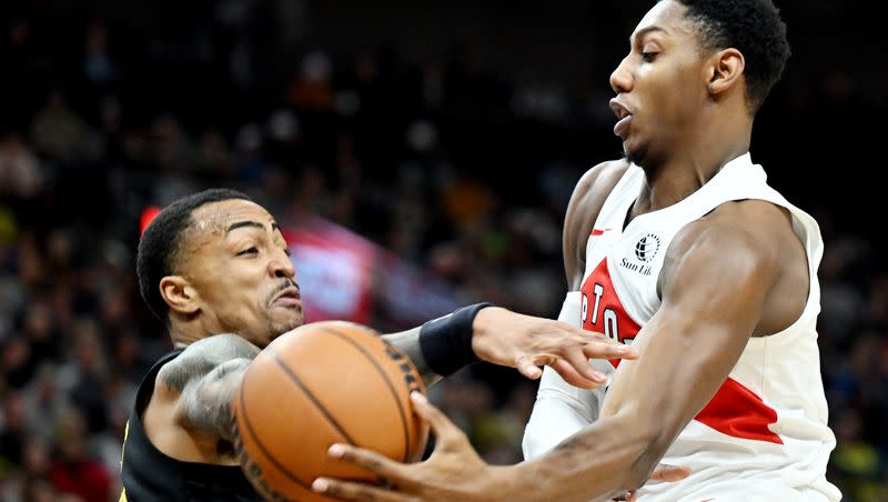 Utah Jazz forward John Collins (20) swipes at the ball as Toronto Raptors guard RJ Barrett (9) goes up with the ball as the Jazz and Raptors play at the Delta Center in Salt Lake City on Friday, Jan. 12, 2024.