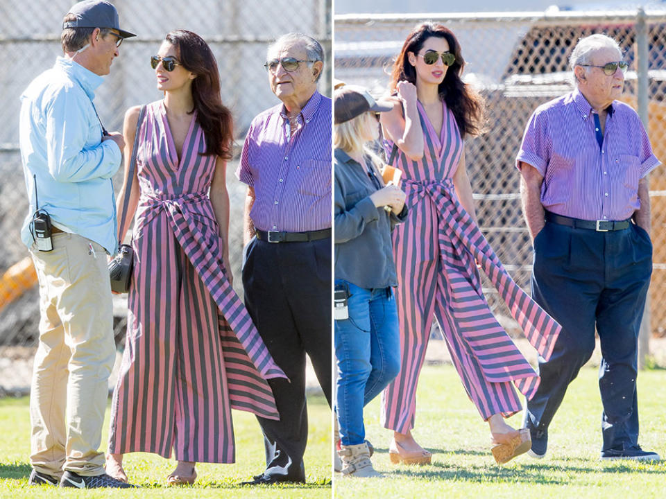 <p>At first glance, it looks like the outfit Amal wore to visit her husband on the set of “Suburbicon” is a striped maxi dress – but it’s actually a lovely jumpsuit by Tome. Clooney let the jumpsuit do the talking, keeping the rest of her look neutral with Linda Farrow aviators, Jimmy Choo sandals and a crossbody bag. However, if you’re hoping to snap up this sweet outfit, it’s going to cost a pretty penny – the jumpsuit alone <a rel="nofollow noopener" href="https://www.modaoperandi.com/tome-r17/striped-cotton-bow-front-jumpsuit?mid=37385&utm_medium=Linkshare&utm_source=Hy3bqNL2jtQ&utm_content=Hy3bqNL2jtQ&siteID=Hy3bqNL2jtQ-IMfKxLWBjFHo119O5BxUcw" target="_blank" data-ylk="slk:retails;elm:context_link;itc:0;sec:content-canvas" class="link ">retails</a> for around $1,400 CAD. <i>(Photos by Splash News)</i></p>