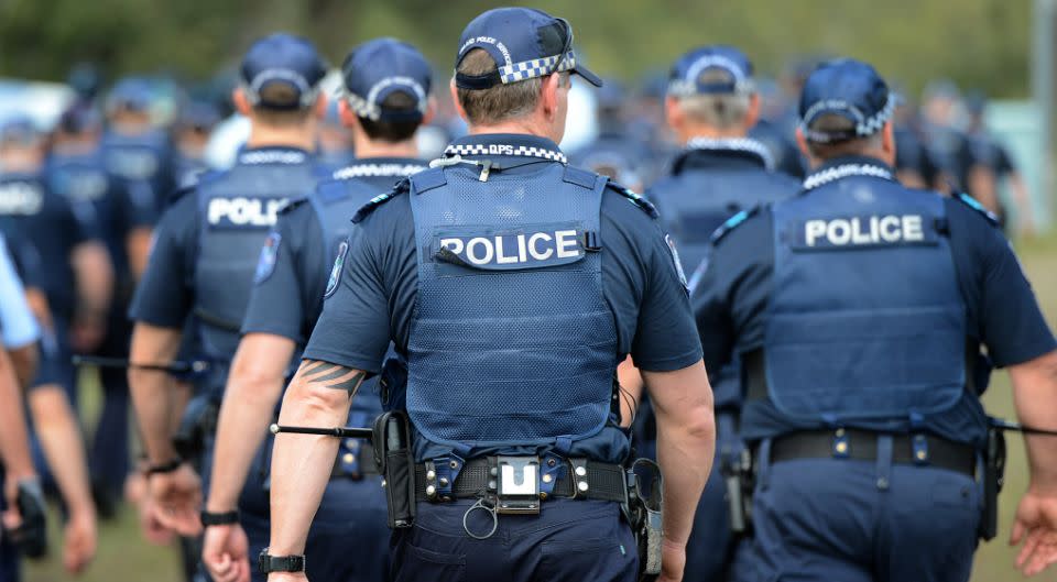 A Queensland Police Service employee has allegedly been found with a cache of semi-automatic weapons. Source: AAP