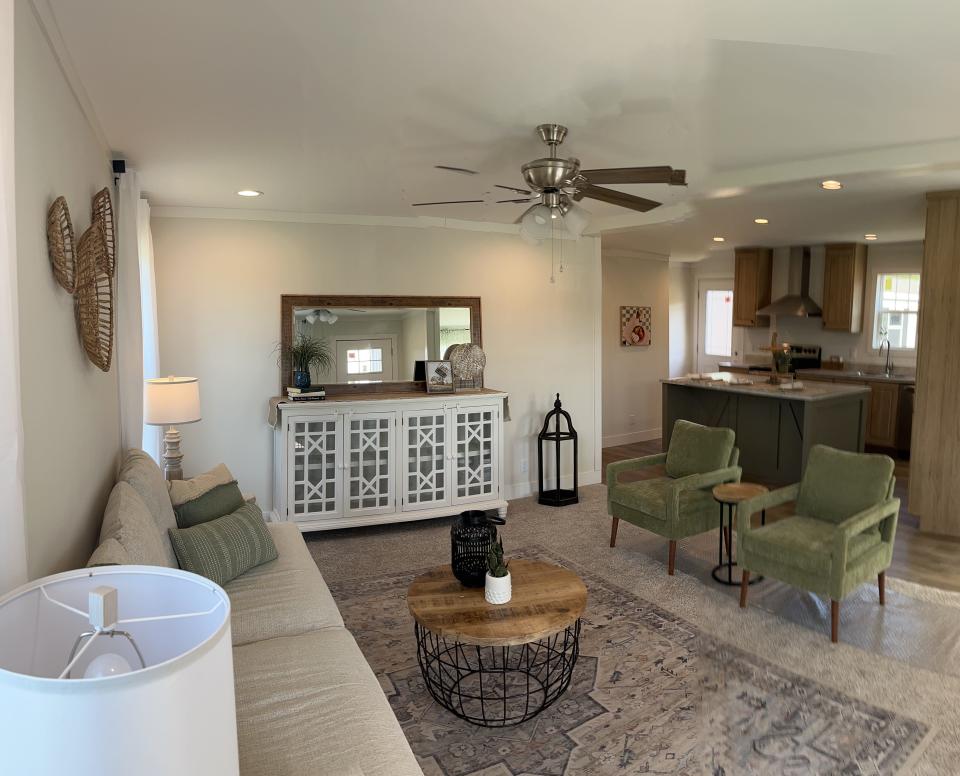 A rendering of a living room and kitchen inside one of the manufactured homes.
