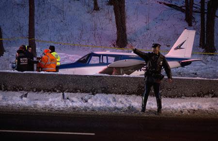 A single engine plane is seen amid vehicle traffic on the Major Deegan Expressway in the Bronx borough of New York January 4, 2014. REUTERS/Carlo Allegri