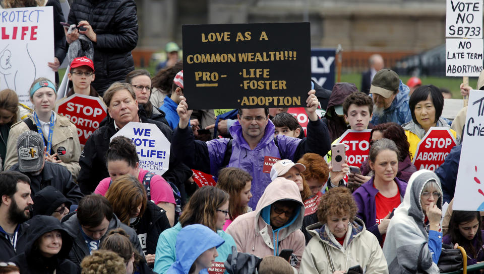 FILE - In this Feb. 13, 2020, file photo, demonstrators hold up a signs during the Virginia March for Life rally outside the Virginia State Capitol in Richmond, Va. Anti-abortion leaders across America were elated a year ago when Donald Trump became the first sitting U.S. president to appear in person at their highest-profile annual event, the March for Life held every January. The mood is more sober now — a mix of disappointment over Trump’s defeat and hope that his legacy of judicial appointments will lead to future court victories limiting abortion rights. (Bob Brown/Richmond Times-Dispatch via AP, File)