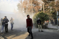 <p>In this photo taken by an individual not employed by the Associated Press and obtained by the AP outside Iran, university students attend a protest inside Tehran University while a smoke grenade is thrown by anti-riot Iranian police, in Tehran, Iran, Saturday, Dec. 30, 2017. (Photo: AP) </p>