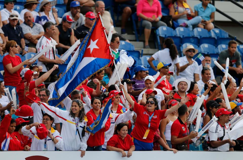 Cuba fans cheer for their team during a Caribbean Series baseball game against Puerto Rico in Porlamar, Venezuela, Tuesday, Feb. 4, 2014. (AP Photo/Fernando Llano)