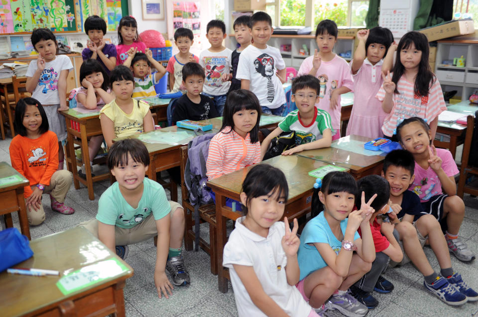 Elementary school student Ryan Kao (bottom left), 7, poses for a photo with his classmates at school in Taipei on June 5, 2013.