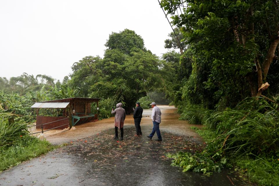 Floods overtake a road in Cayey on Sunday (AP)