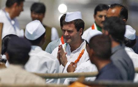 Rahul Gandhi (C) gestures to his party workers before addressing a rally ahead of the 2014 general elections at Balasinor town in Gujarat March 11, 2014. REUTERS/Amit Dave