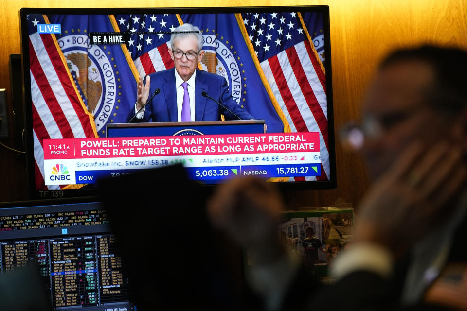 A screen displays a news conference with Federal Reserve Chairman Jerome Powell as traders work on the floor at the New York Stock Exchange in New York, Wednesday, May 1, 2024. (AP Photo/Seth Wenig)