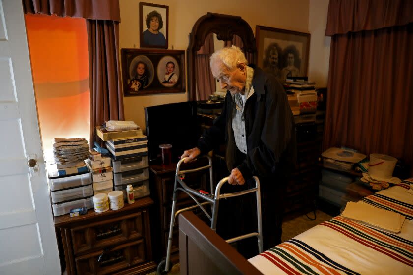 LOS ANGELES, CA - FEBRUARY 17: Paul Hult, 102, is a WWII veteran and retired Southern Pacific railroad switch man. He's on a tight budget and spends most of his income on 24-7 home health aids, shown at his apartment on Friday, Feb. 17, 2023 in Los Angeles, CA. Hult's $500 plus gas bill has hit him hard, he says he may have to give up his caretakers. Paul has lived at the Rose Garden Court apartments since 1951. He was born Januaray 8th,1921 and married to his wife Zora Hult, from 1948 to 2005. Zora was from Croatia where he met her after the war while he was still in the service. They were married and he brought her and her three children over to the United States. (Gary Coronado / Los Angeles Times)