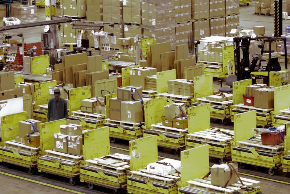 Worker walks between rows of automated cars at the Defense Logistics Agency's giant storage facility outside Harrisburg, Pennsylvania