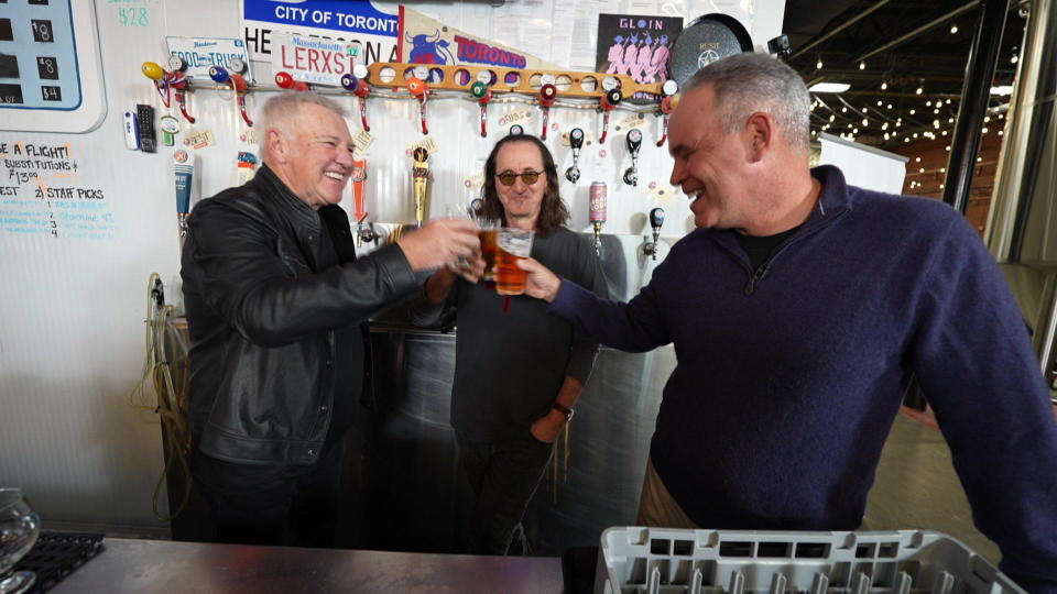 Alex Lifeson and Geddy Lee, of the rock band Rush, with correspondent Jim Axelrod, sampling some 