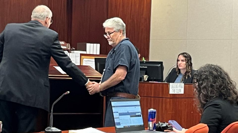 Damien Gilliams, 62, in handcuffs, greets his attorney Jeffrey Garland, at left, during a hearing at the Indian River County Courthouse on Monday, Oct. 30, 2023. Gilliams was ordered to remain in the Indian River County Jail to finish serving a 45-day sentence related to three misdemeanor Sunshine Law convictions.