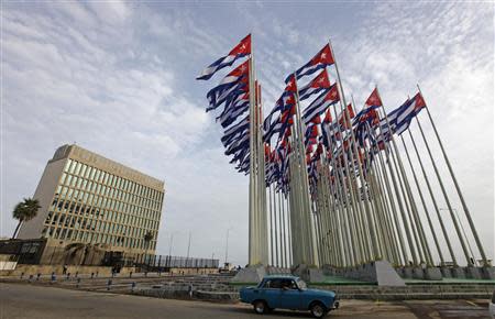 A car drives past the building of the the U.S. diplomatic mission in Cuba, The U.S. Interests Section, (USINT), in Havana, in this September 12, 2013 file picture. REUTERS/Desmond Boylan/Files