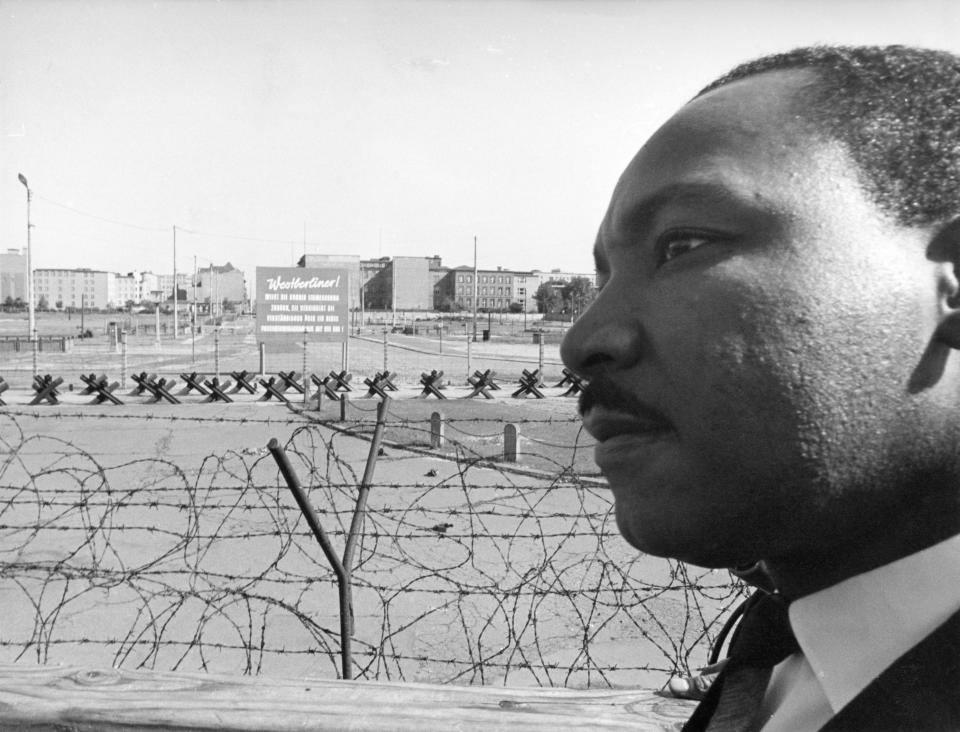 Reverend Martin Luther King, American civil rights leader, invited to Berlin by West Berlin Mayor Willy Brandt, visits on September 13, 1964 the red wall. Here he is seen at the border Potsdamer Platz, West Berlin, Germany.