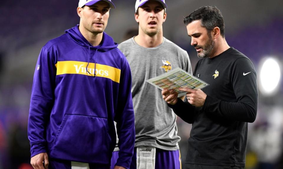 MINNEAPOLIS, MN - NOVEMBER 25: Quarterbacks Kirk Cousins #8 and Trevor Siemian #3 of the Minnesota Vikings, and quarterbacks coach Kevin Stefanski talk on field before the game against the Green Bay Packers at U.S. Bank Stadium on November 25, 2018 in Minneapolis, Minnesota. (Photo by Hannah Foslien/Getty Images)