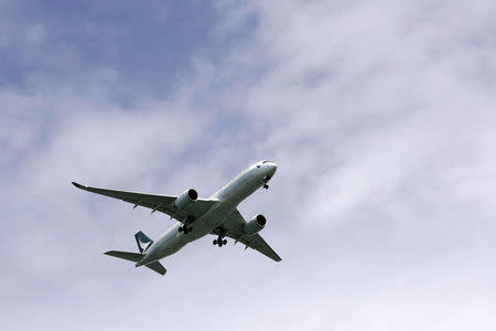 A Cathay Pacific Airways passenger plane flies, in Hong Kong, China August 15, 2017. Picture taken August 15, 2017. REUTERS/Tyrone Siu