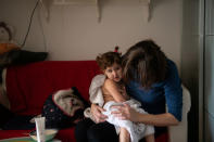 Maria, 31, dries Elena, who is two years and seven-months old, after giving her a bath after nursery, at home in London, Britain, February 22, 2019. REUTERS/Alecsandra Dragoi