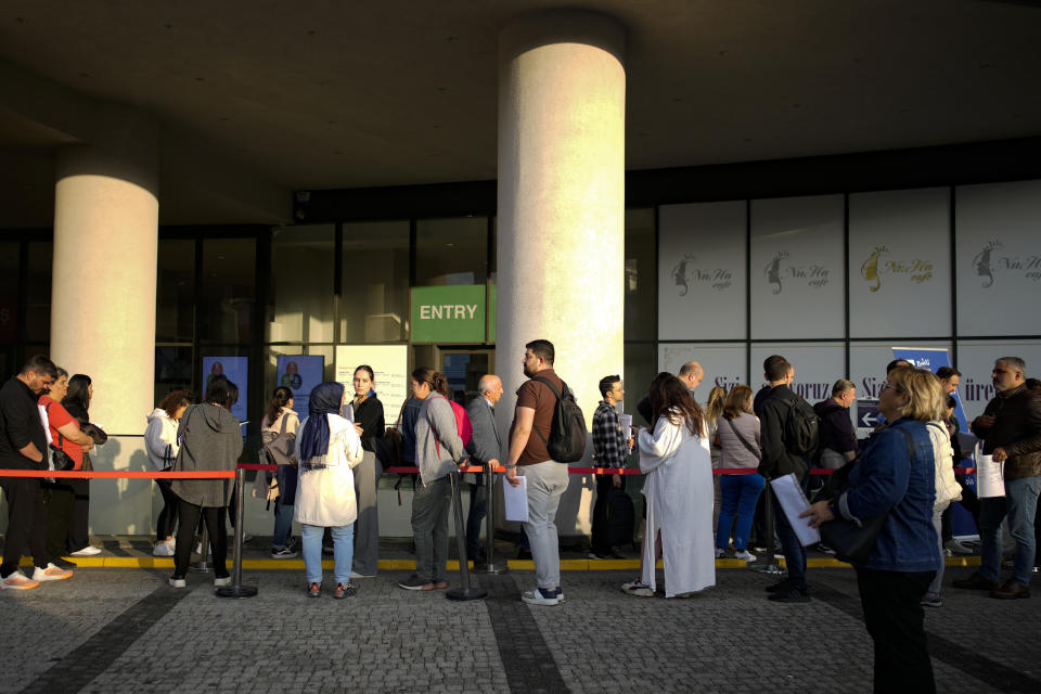People wait for their turn at a visa application center, in Istanbul, Friday, Nov. 3, 2023. Turkey is marking its centennial but a brain drain is casting a shadow on the occasion. Government statistics indicate that a growing number of the young and educated are looking to move abroad in hopes of a better life, mainly in Europe. (AP Photo/Emrah Gurel)