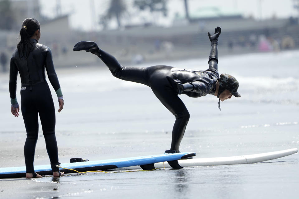 Seiichi Sano, an 89-year-old Japanese man, practices during a surfing lesson at Katase Nishihama Beach, Thursday, March 30, 2023, in Fujisawa, south of Tokyo. Sano, who turns 90 later this year, has been recognized by the Guinness World Records as the oldest male to surf. (AP Photo/Eugene Hoshiko)