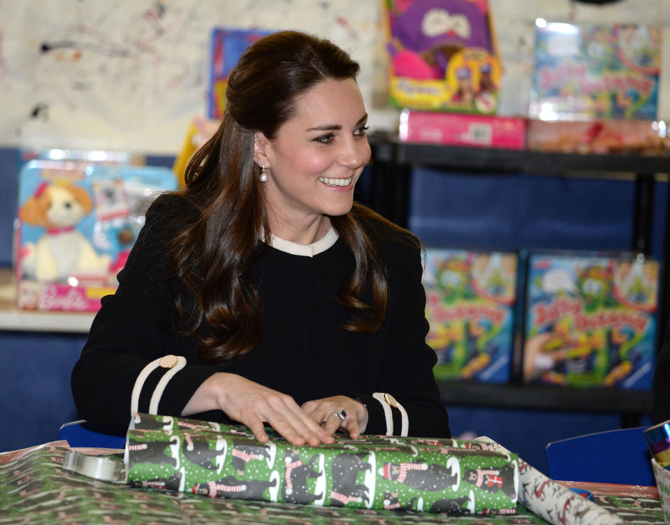 The Duchess of Cambridge wraps presents in New York, in 2013 [Photo: Getty]