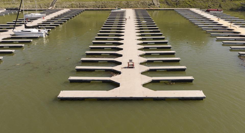 Docks float in the Browns Ravine Cove area of Folsom Lake in Folsom, Calif., Sunday, March 26, 2023. Months of winter storms have replenished California's key reservoirs after three years of punishing drought. (AP Photo/Josh Edelson)