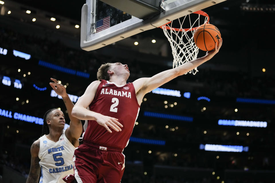 Alabama forward Grant Nelson (2) score past North Carolina forward Armando Bacot (5) of a Sweet 16 college basketball game in the NCAA tournament Thursday, March 28, 2024, in Los Angeles. (AP Photo/Ashley Landis)