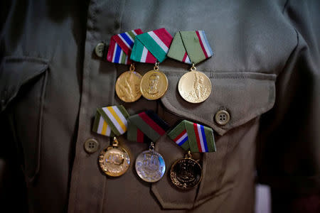 Former rebel Nelson Alvarez, 85, shows his medals in his home in El Cobre, Cuba, April 2, 2018. REUTERS/Alexandre Meneghini