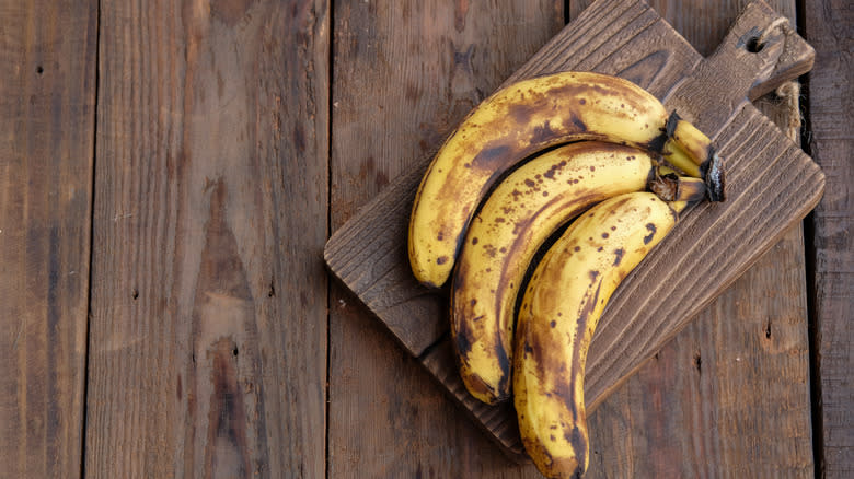Ripe bananas on cutting board