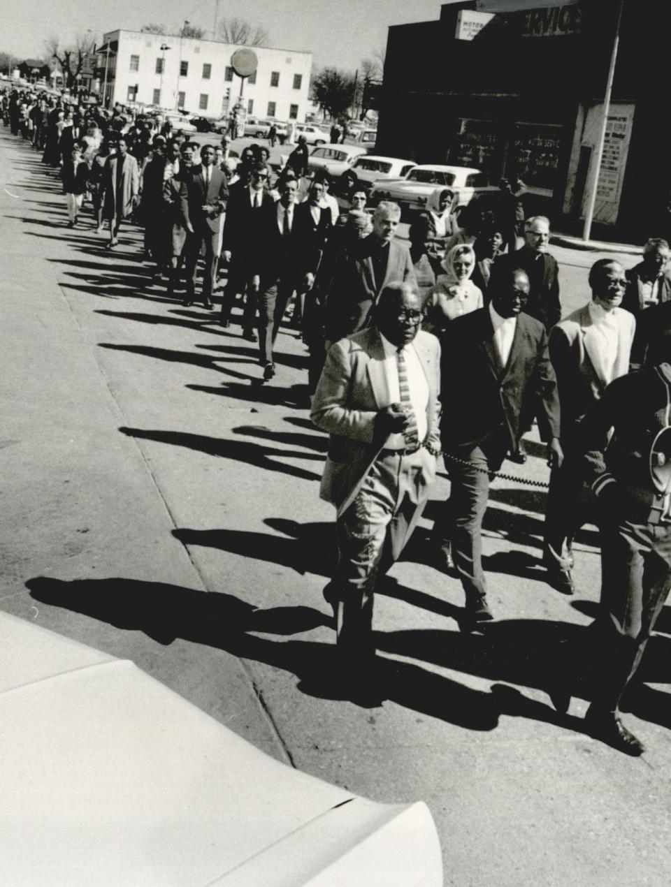 On April 6, 1968, Lawton minister N.H. Jones holds a microphone as he leads 300 people on a five-block march through Lawton to honor Martin Luther King Jr., who had been slain two days earlier in Memphis, Tenn.