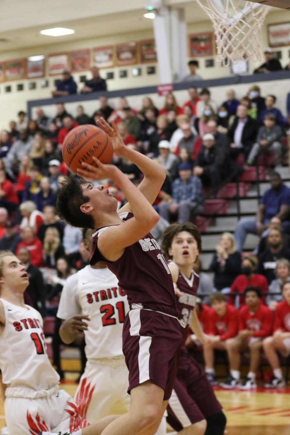 Genoa's Skylar Ju drops in a layup on his way to a three-point play.