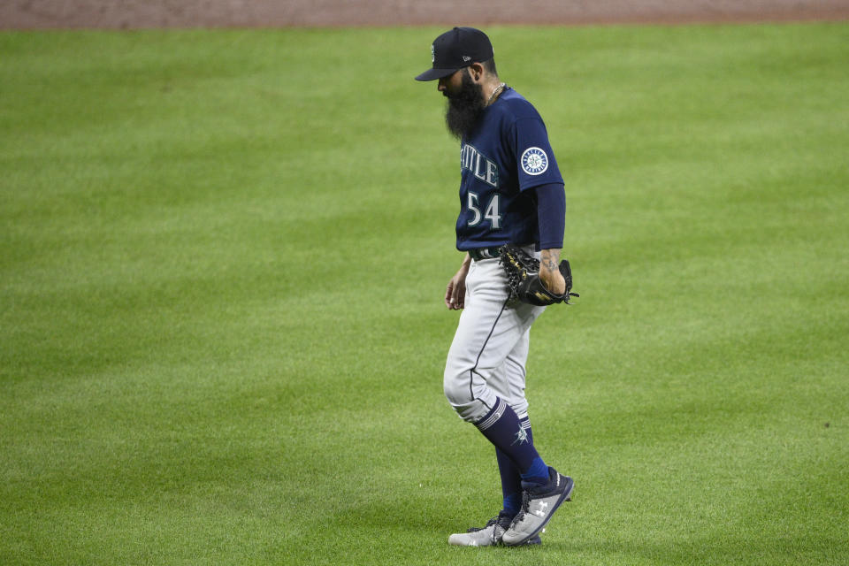 Seattle Mariners relief pitcher Sergio Romo walks back to the dugout after he was pulled during the sixth inning of the team's baseball game against the Baltimore Orioles, Wednesday, June 1, 2022, in Baltimore. (AP Photo/Nick Wass)