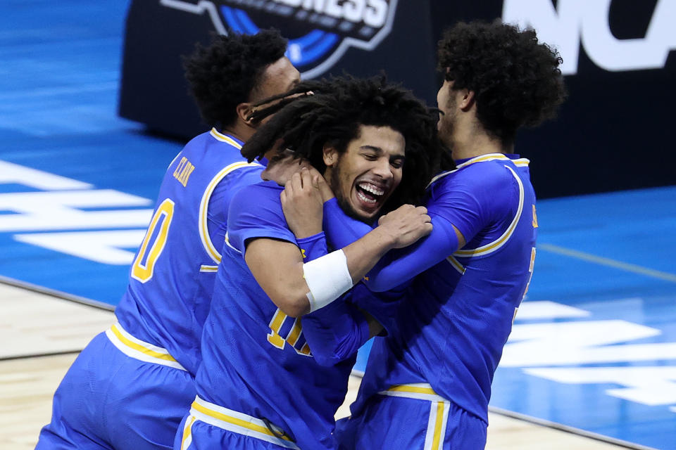 INDIANAPOLIS, INDIANA - MARCH 30: Tyger Campbell #10 and Johnny Juzang #3 of the UCLA Bruins celebrate defeating the Michigan Wolverines 51-49 in the Elite Eight round game of the 2021 NCAA Men's Basketball Tournament at Lucas Oil Stadium on March 30, 2021 in Indianapolis, Indiana. (Photo by Andy Lyons/Getty Images)