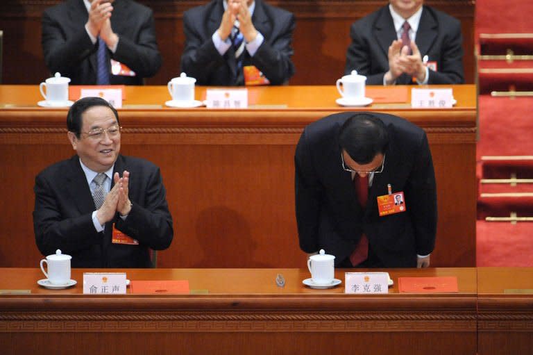 Newly-elected Chinese Premier Li Keqiang bows to delegates during the 12th National People's Congress (NPC) in the Great Hall of the People in Beijing on March 15, 2013