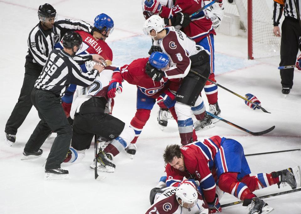 Montreal Canadiens and Colorado Avalanche players brawl during the third period of an NHL hockey game in Montreal, Saturday, Dec. 10, 2016. (Graham Hughes/The Canadian Press via AP)