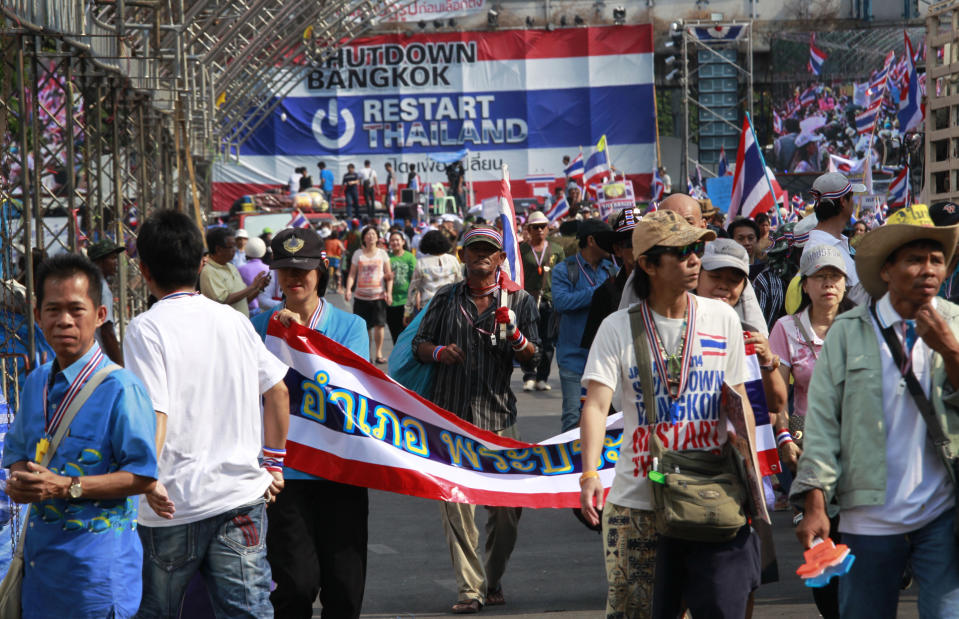 Protesters carrying their belongings participate in the last march from the main protest stage before it is removed from a popular intersection in Bangkok, Thailand, Sunday, March 2, 2014. The anti-government protesters withdrew from several stages erected at key intersections around Bangkok. Starting Monday, they will consolidate at Lumpini Park, a central venue that has become a traditional protest site. (AP Photo/Wally Santana)